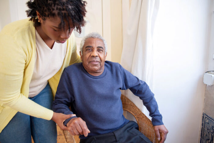 Elderly woman receiving home care assistance from a MetroPlusHealth caregiver through the Managed Long Term Care plan in New York.