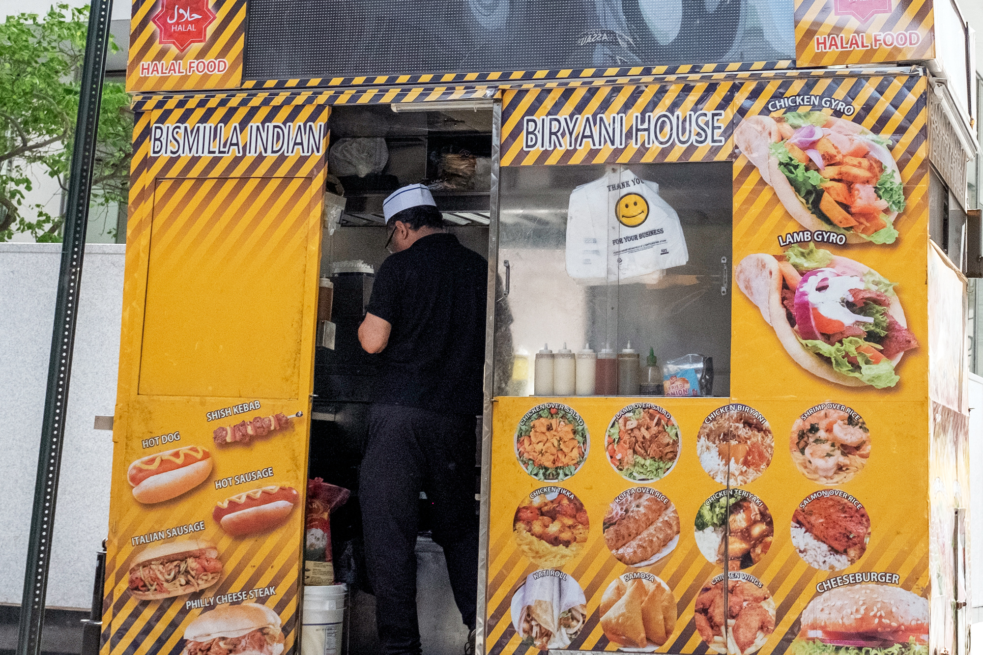 A man working in a street food cart