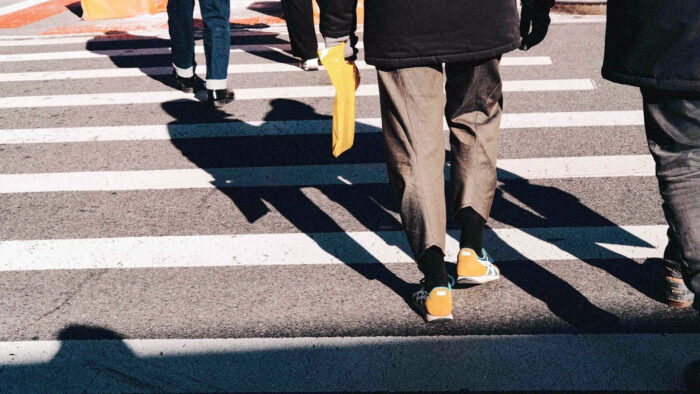 People crossing a street within a crosswalk