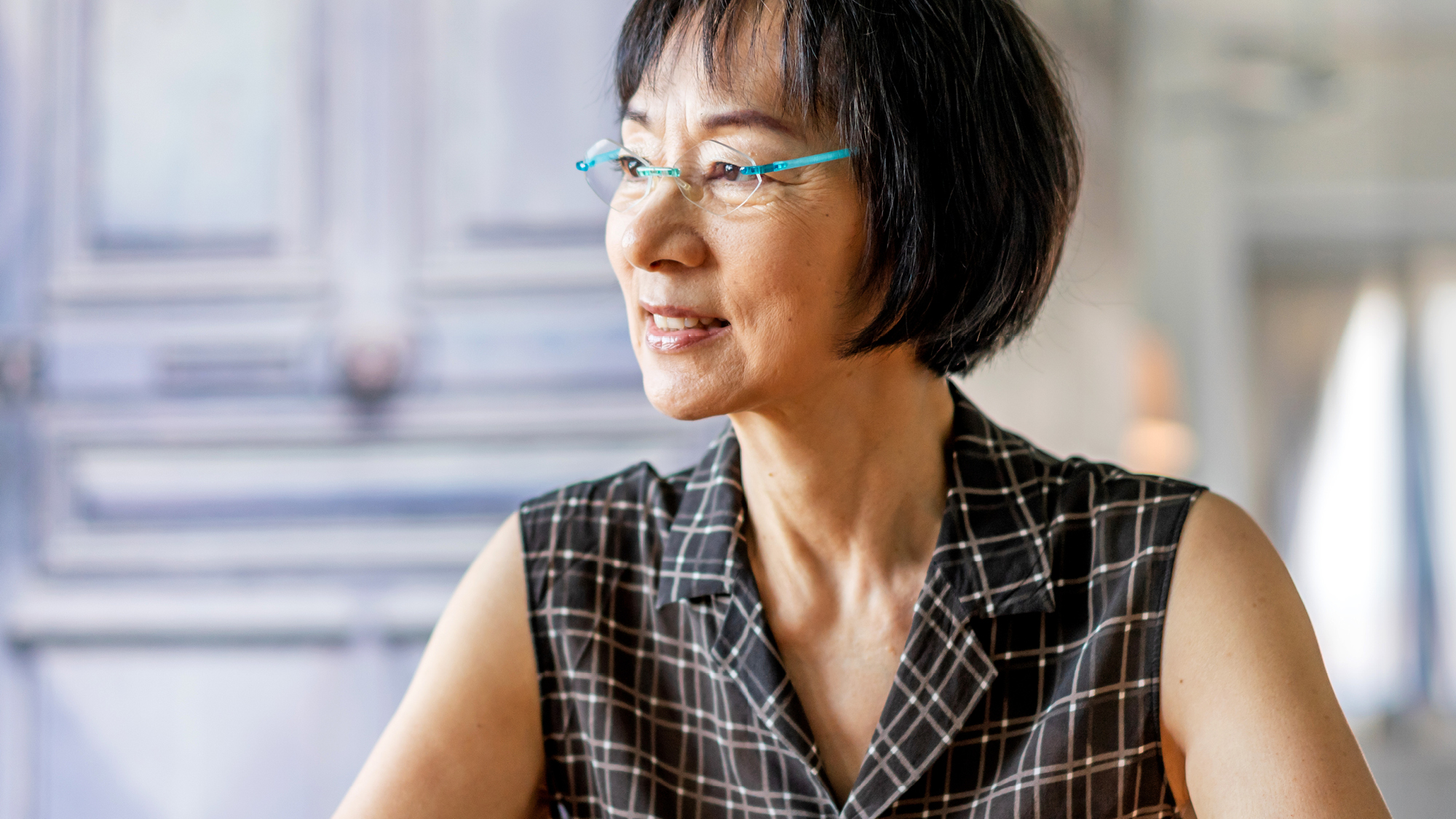 A woman wearing glasses sitting at a table